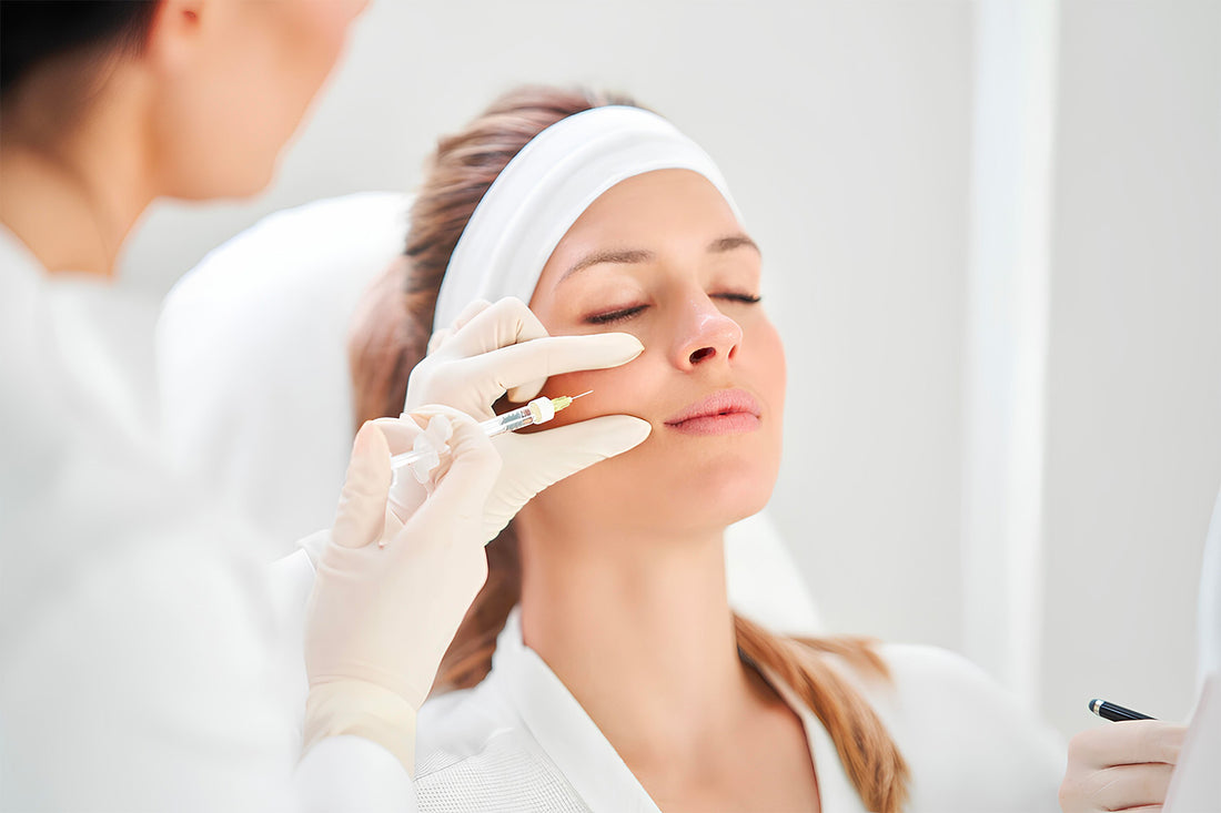 Mujer recibiendo un inyectable en el rostro.